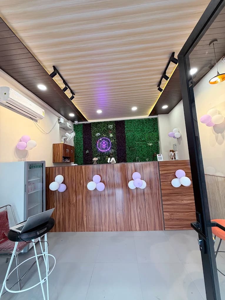 The walnut service counter from the doorway, moss wall and neon logo behind it