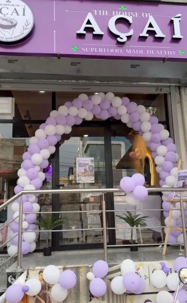 The purple House of Açaí storefront on Queens Road under a balloon arch